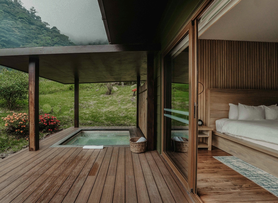 A villa's bedroom at El Silencio with a Jacuzzi on its wooden deck.