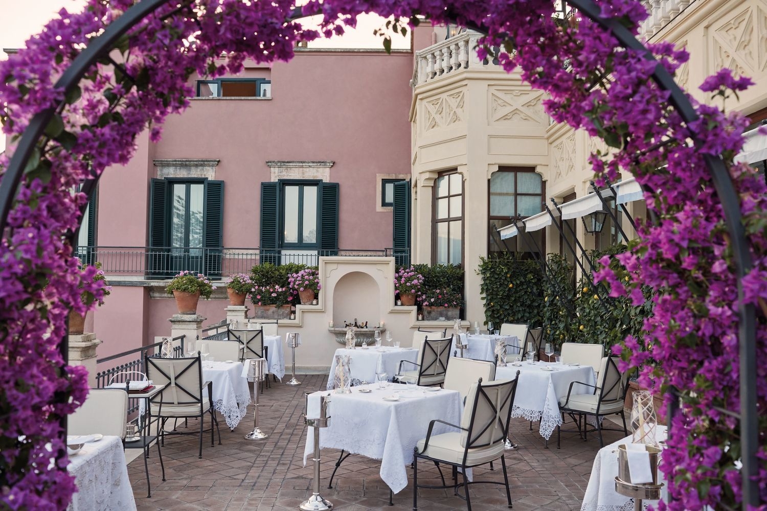 Outdoor dining with bougainvilla at Belmond Grand Hotel Timeo