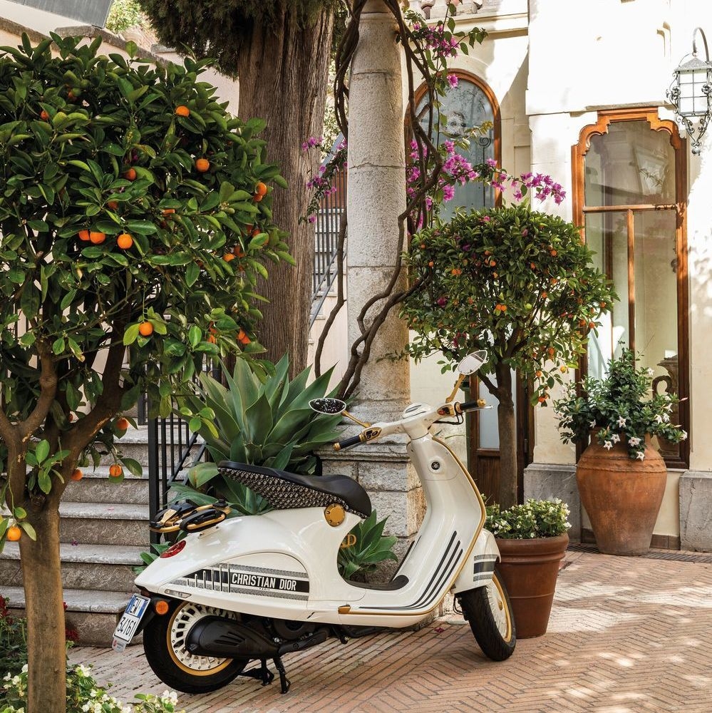 A vintage scooter parked outside Belmond Grand Hotel Timeo