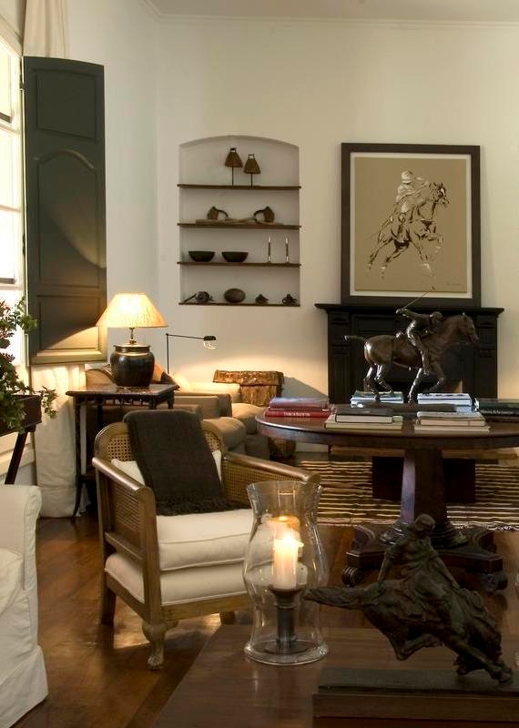 Elegant living room with classic furniture, wall art, and warm lighting.