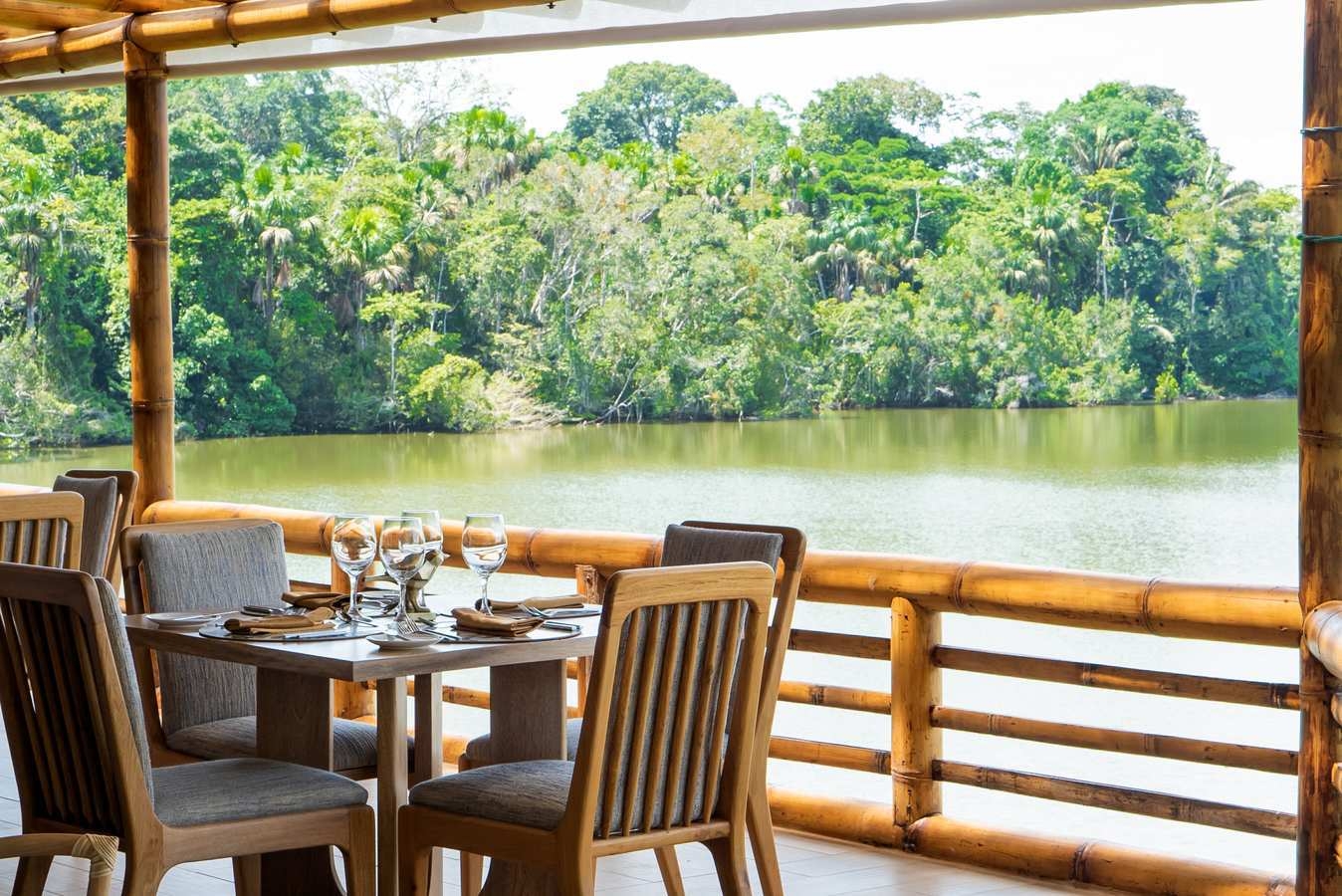 A dining table lagoon-side at La Selva Lodge.