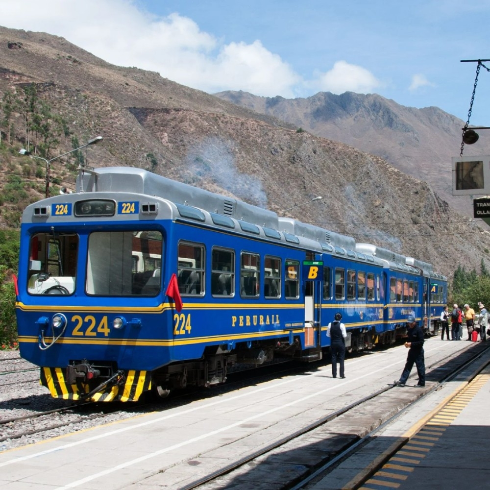 Blue Vistadome train pulling out of the station on it's journey between the Sacred Valley and Machu Picchu, Peru