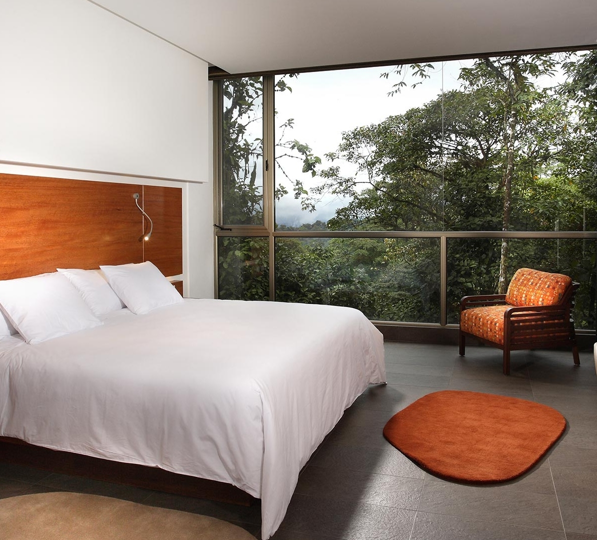 A bedroom at Mashpi Lodge overlooking the forest.
