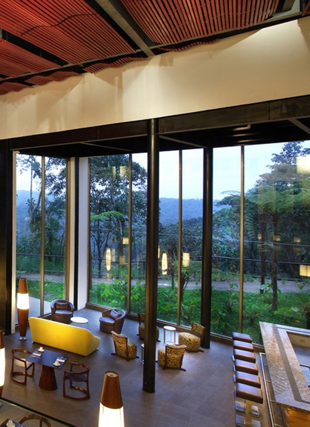 Mashpi Lodge's restaurant with panoramic windows overlooking the forest.