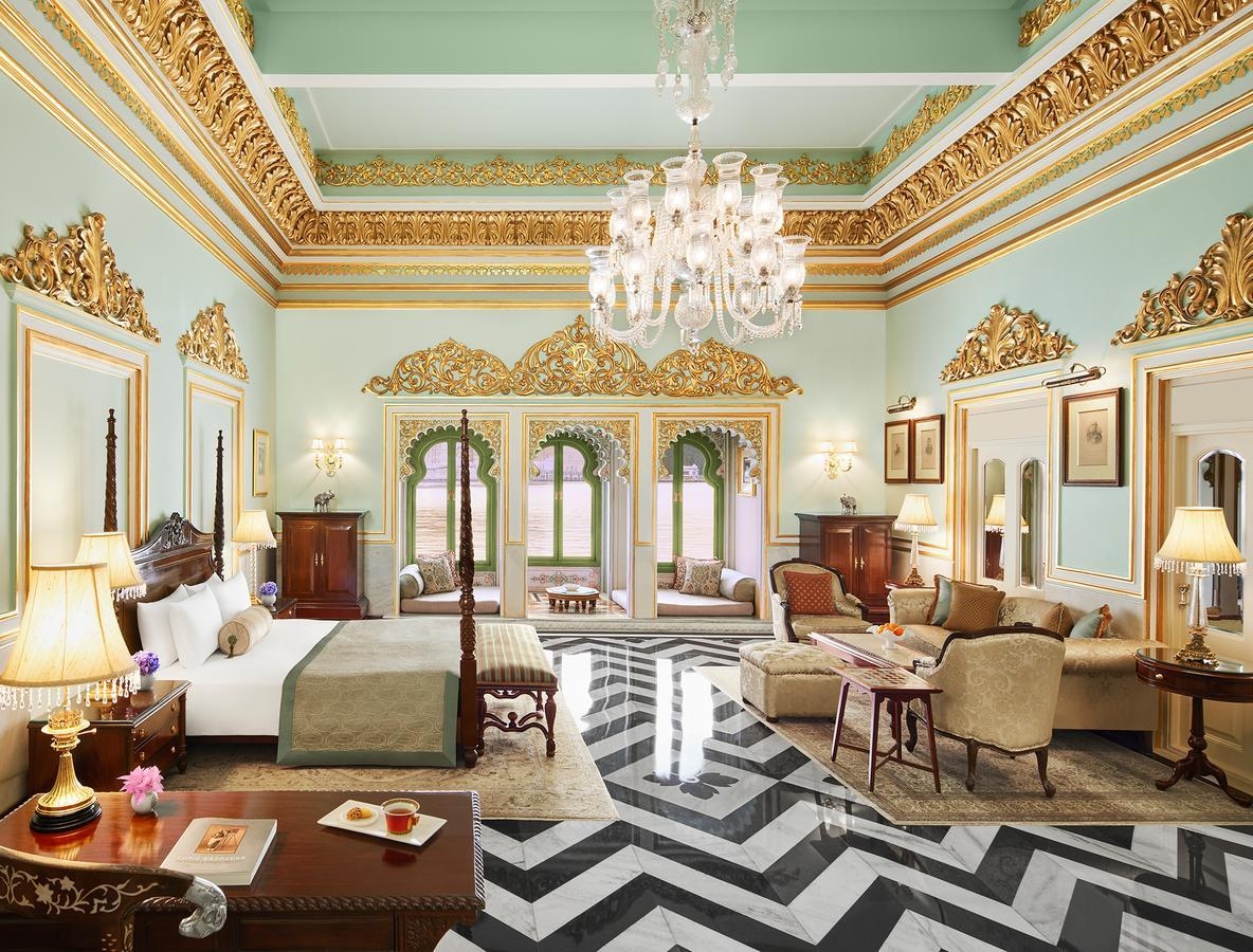 A stately, ornately-styled bedroom at Taj Lake Palace which faces the lake.