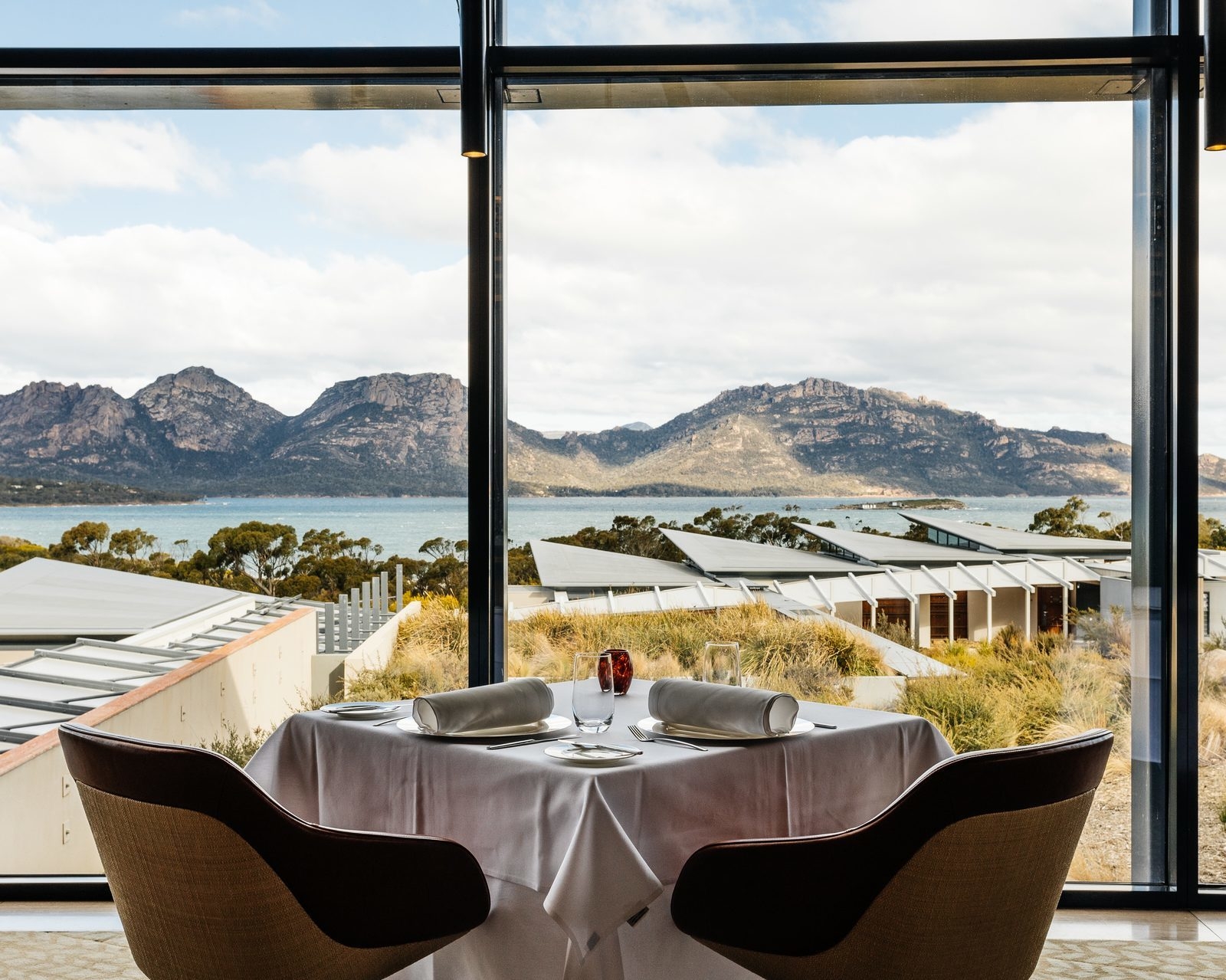 A dining table with outside views in the restaurant at Saffire Freycinet