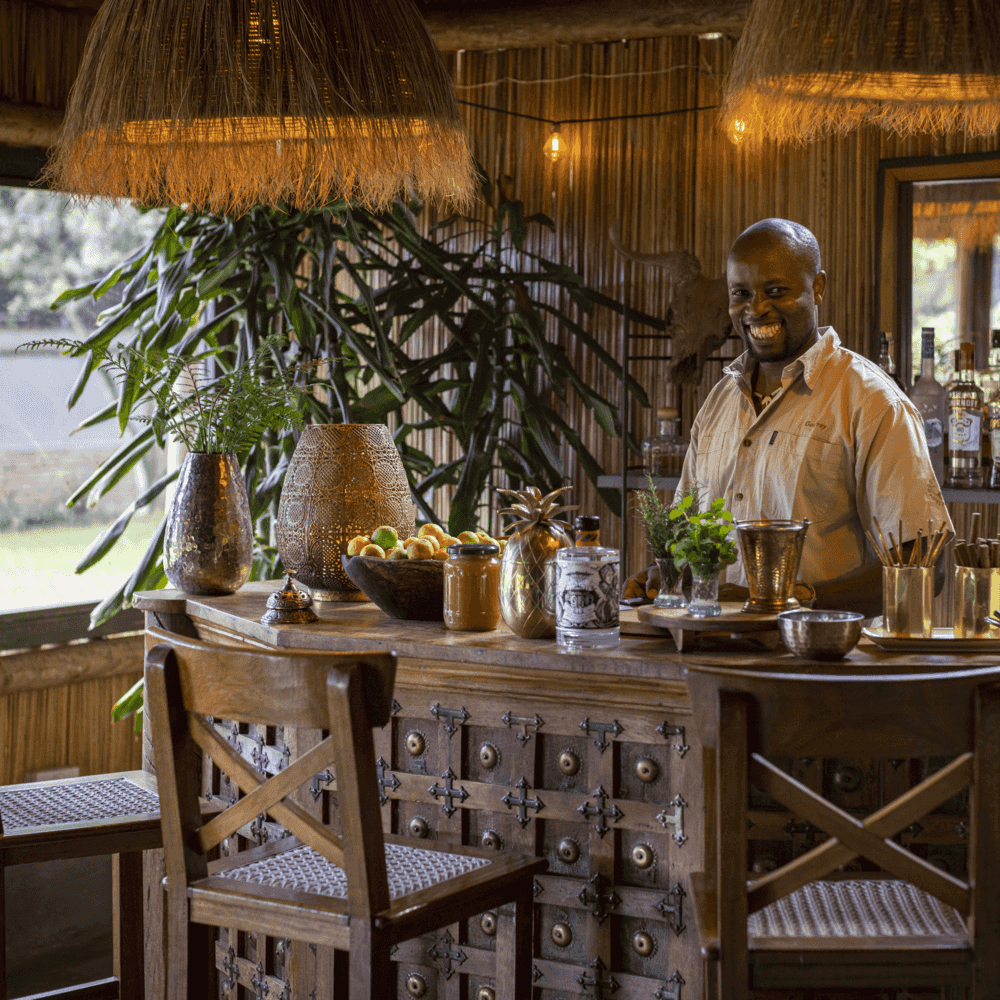 smiling man behind the bar at House in the Wild