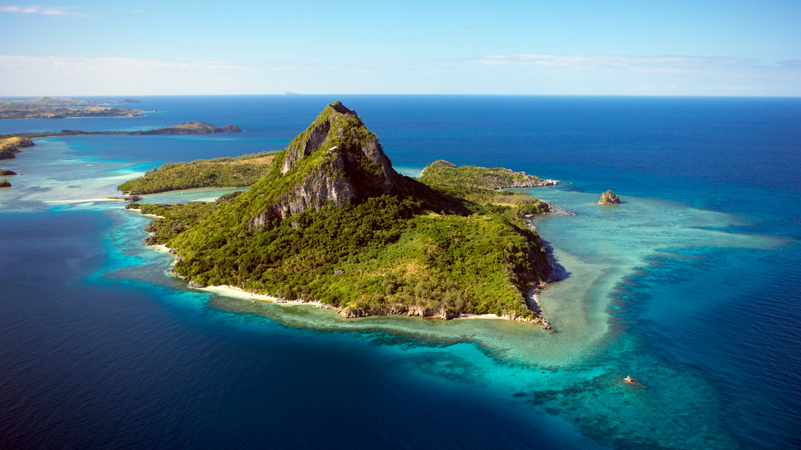 Aerial view of Yasawa Islands in Fiji surrounded by sapphire blue waters.
