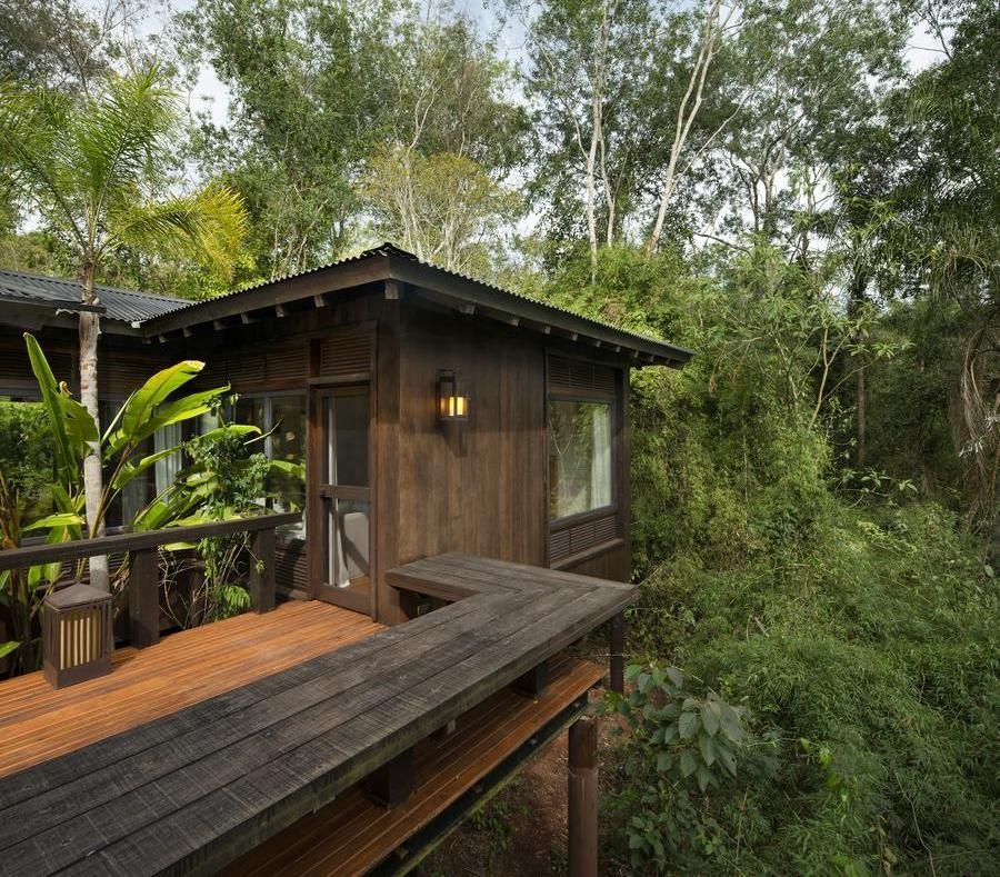 A wooden villa surrounded trees at Awasi Iguazu.