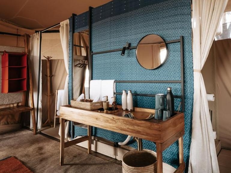 Usawa camp bathroom area with amenities, towels and decoration