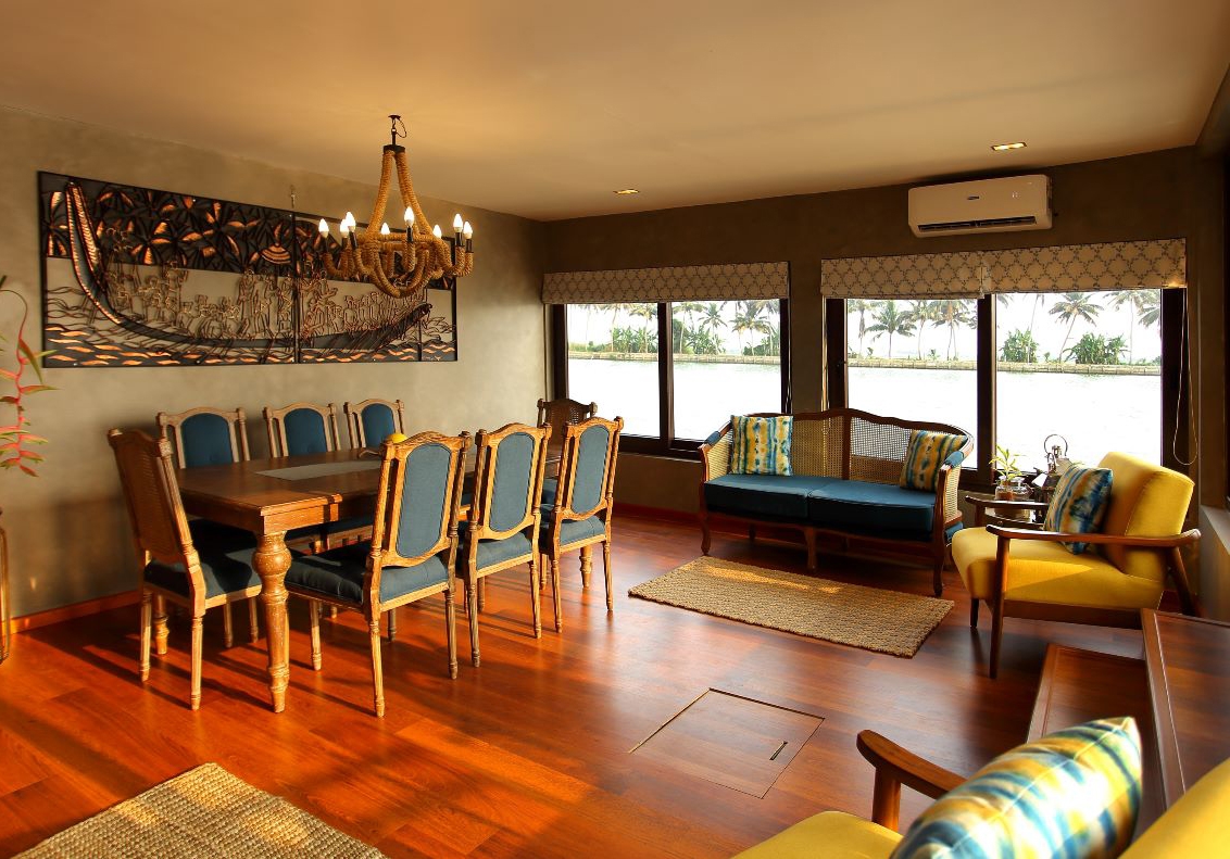 Elegant dining and living room with traditional decor overlooking a water view.