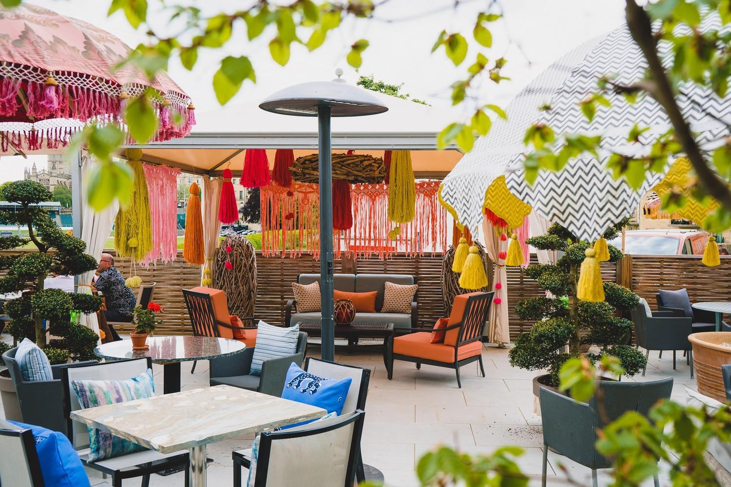 Outdoor terrace with colourful parasols at The Bird hotel, Bath