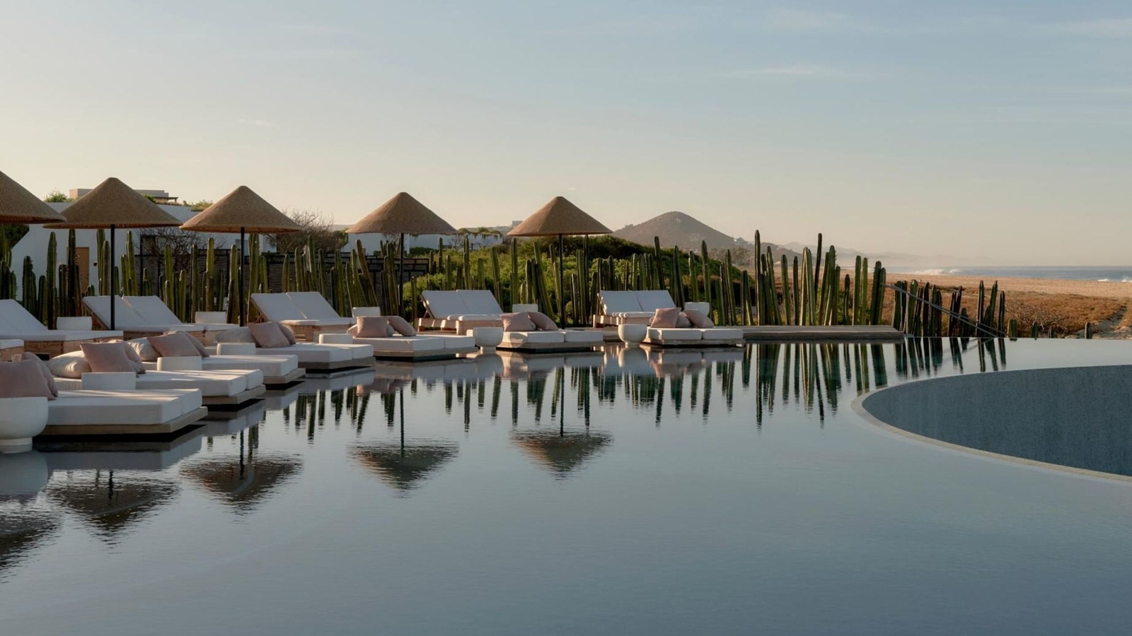 view of the pool with sun loungers round the edge at Kimpton Mas Olas, Baja California