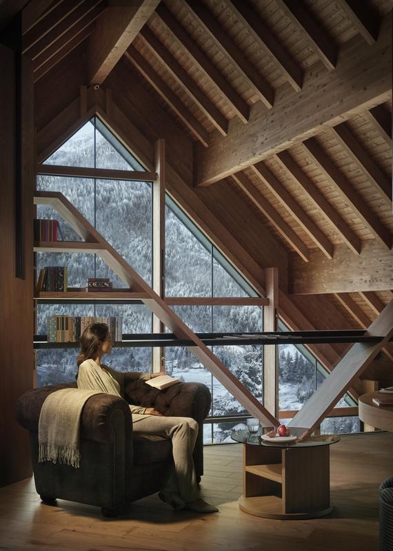 A woman relaxes in the reading room at Lefay Dolomiti