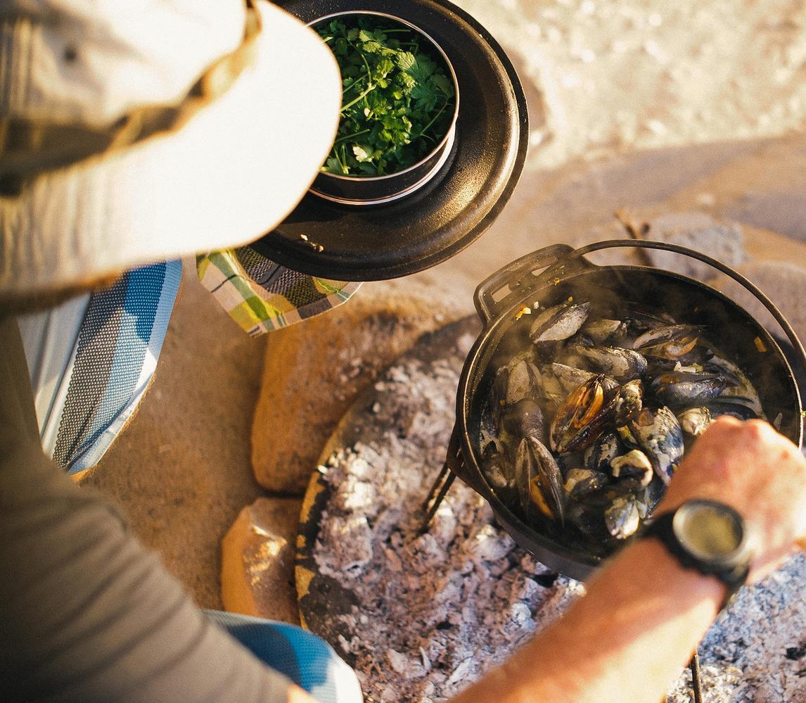 Fresh mussels cooked over an open fire on the sand.