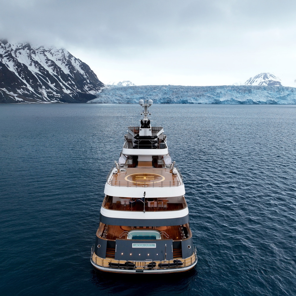An aerial view of the rear area of luxury expedition vessel Aqua Lares cruising in the Arctic.