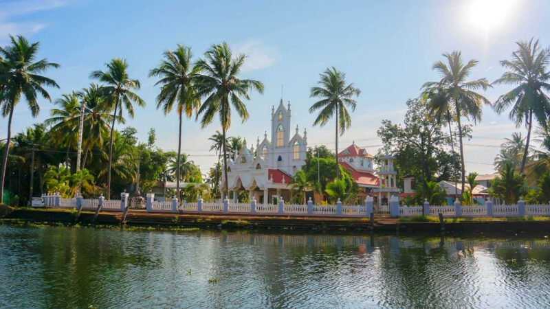 The Church of St. Joseph on the water and surrounded by palm trees in Alleppey, India.