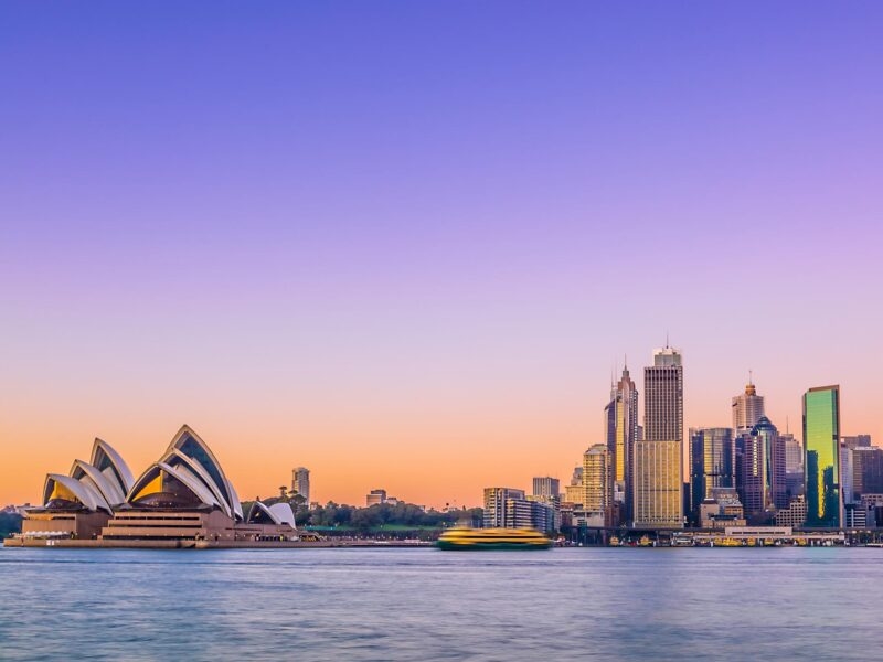 The Sydney Opera House and city skyline at twilight, a staple of luxury Australasia trips.