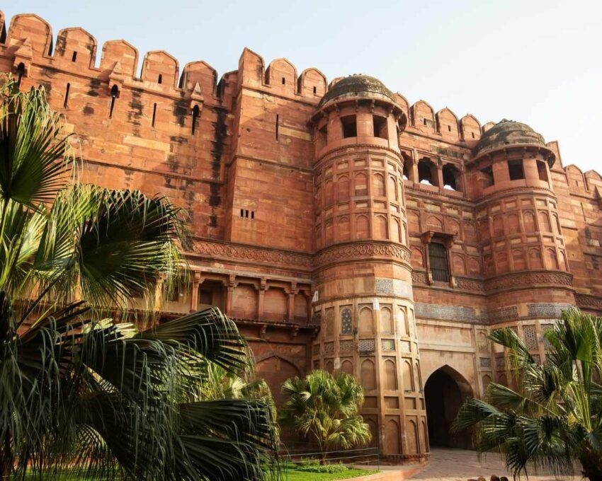 Agra Fort, a red-coloured stone fort with cylindrical towers and ramparts