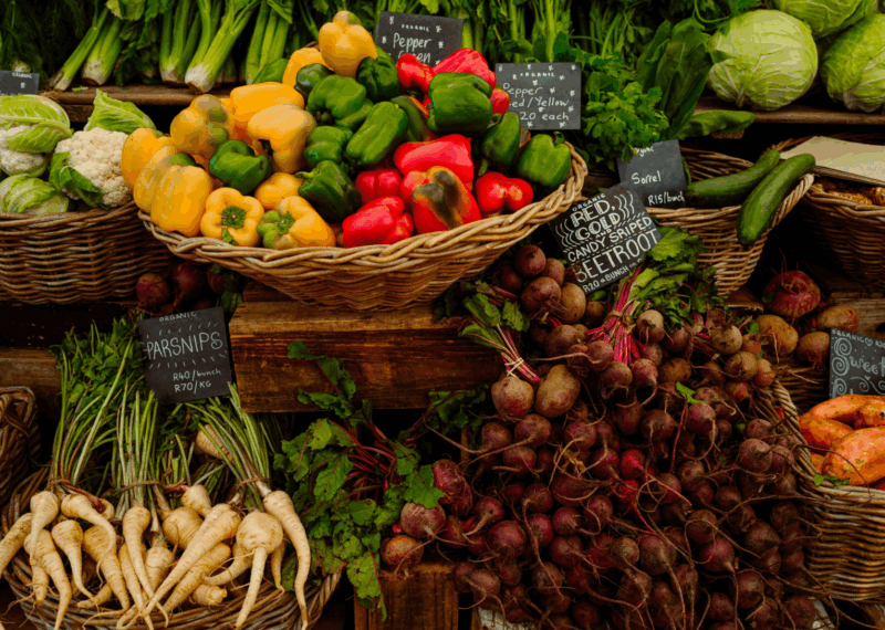 A market stall of bright and fresh vegetables.