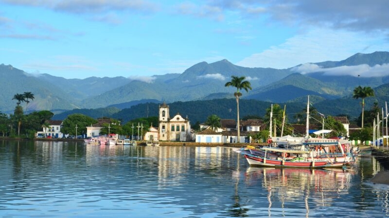 The town of Paraty, Brazil, with boats floating on the ocean in front of it
