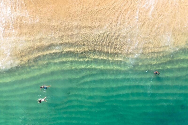 aerial photo of beach with green ocean at Los Cabos, Mexico