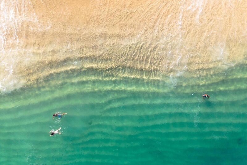 aerial photo of beach with green ocean at Los Cabos, Mexico
