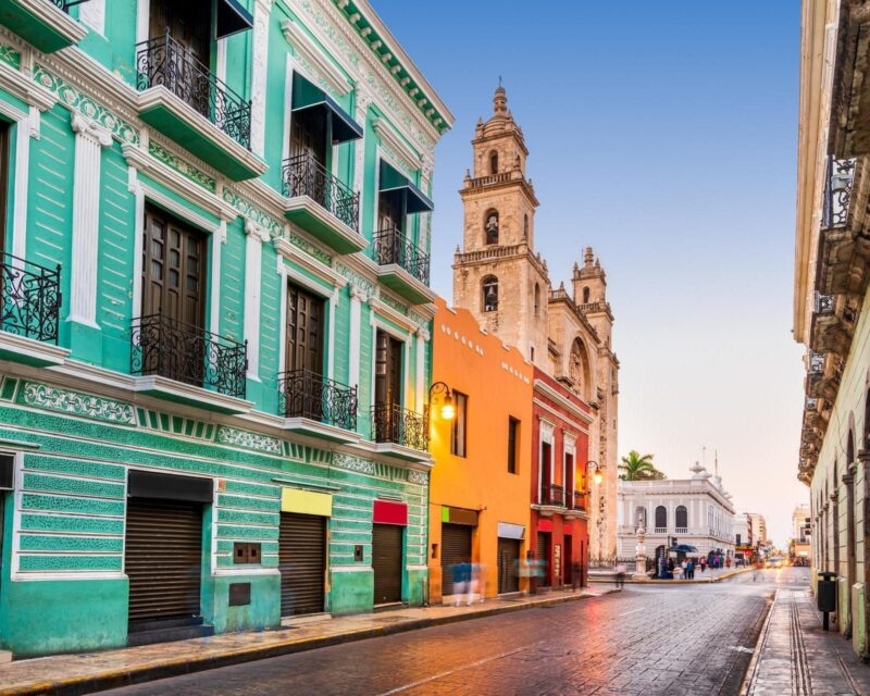 San Ildefonso cathedral seen behind colourful buildings in Mérida, Mexico