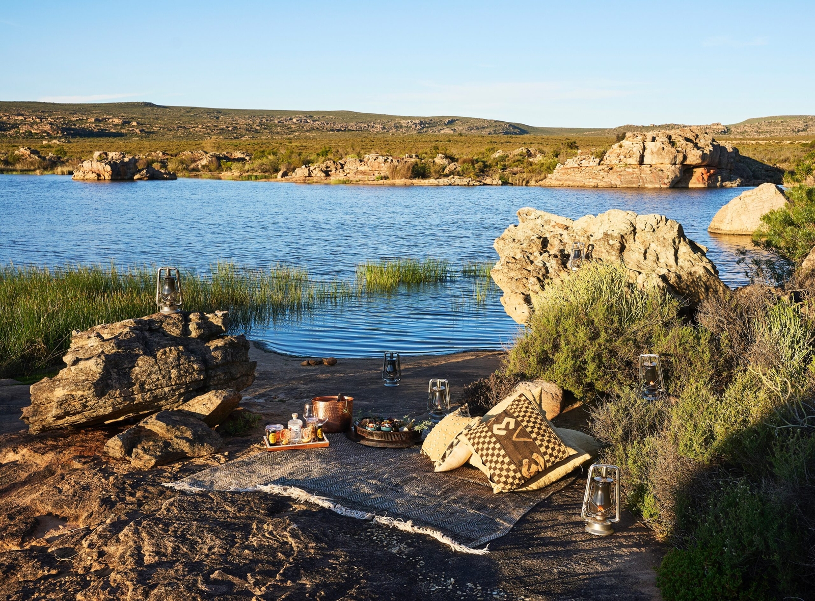 Luxury outdoor patio space with stylish furniture overlooking scenic landscape.