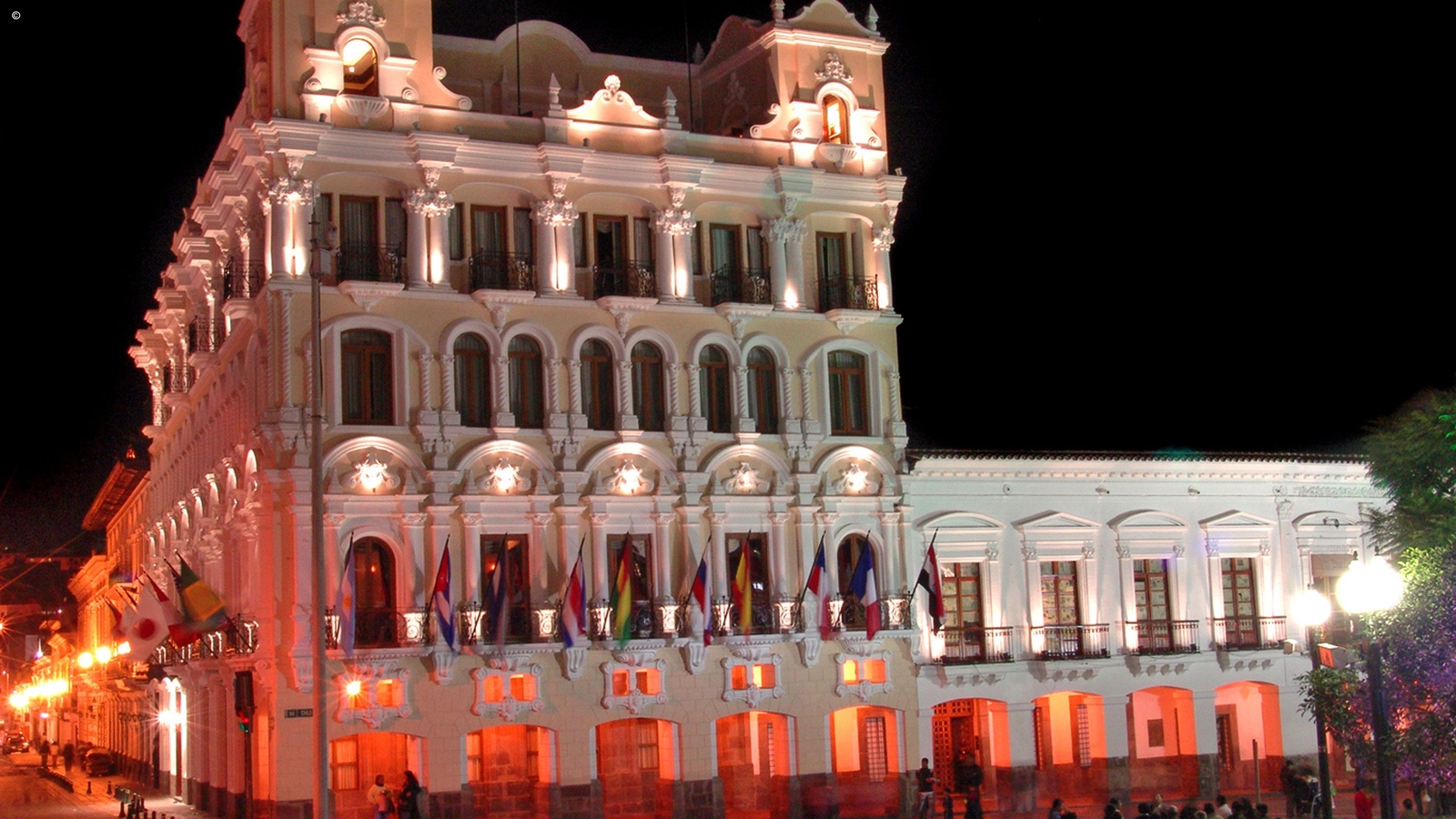 Ornate exterior of Hotel Plaza Grande illuminated at night, Quito, Ecuador