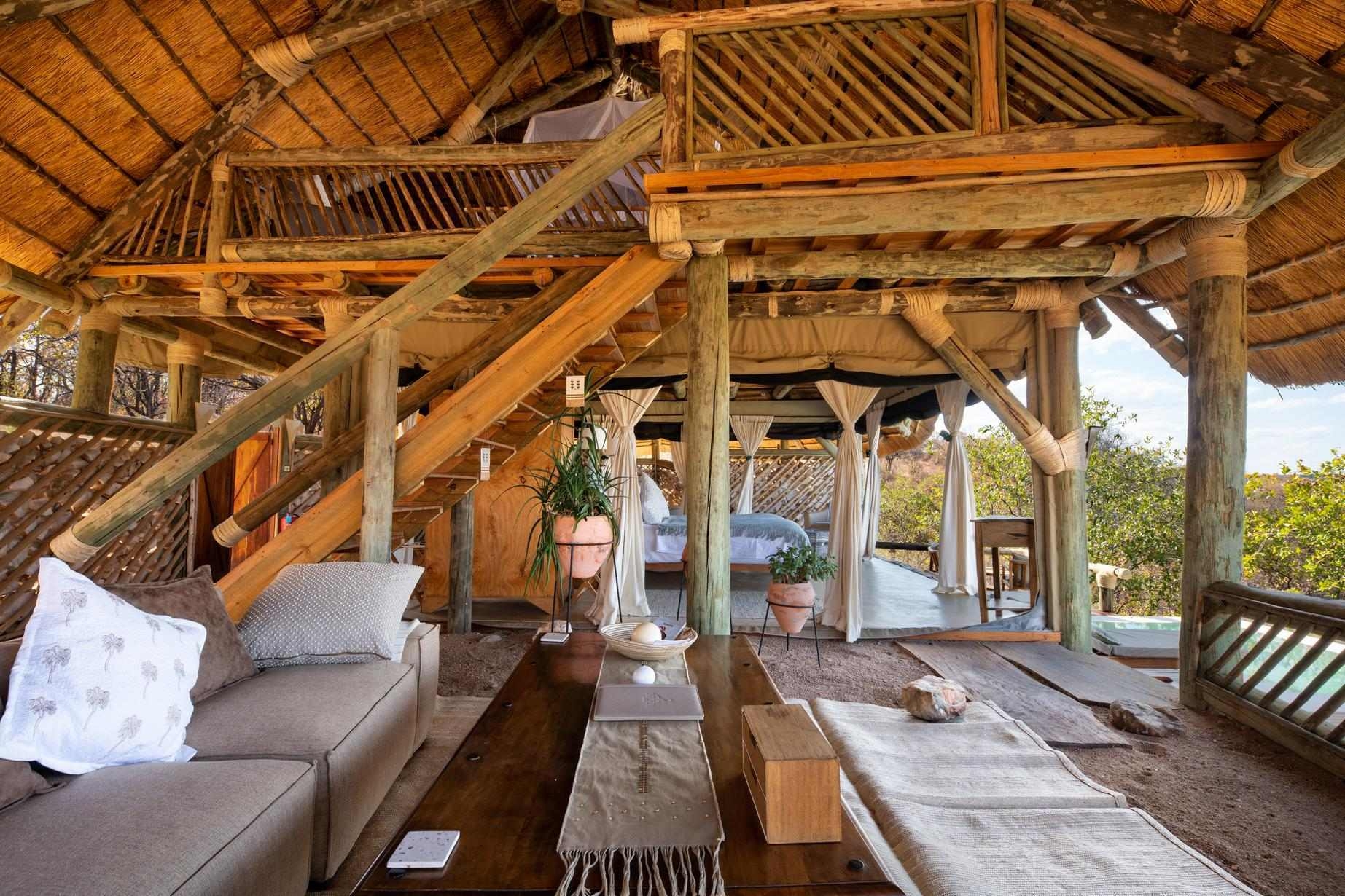 The open-air, wood-laden family room at Ikuka Safari Camp with a mezzanine level.