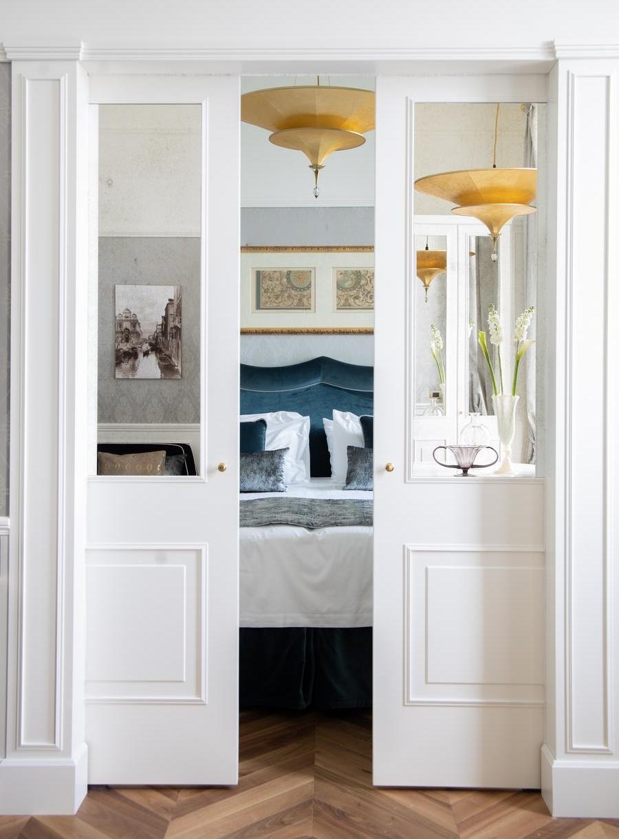 A glimpse of a suite's bedroom from the lounge at Hotel Londra Palace in Venice.