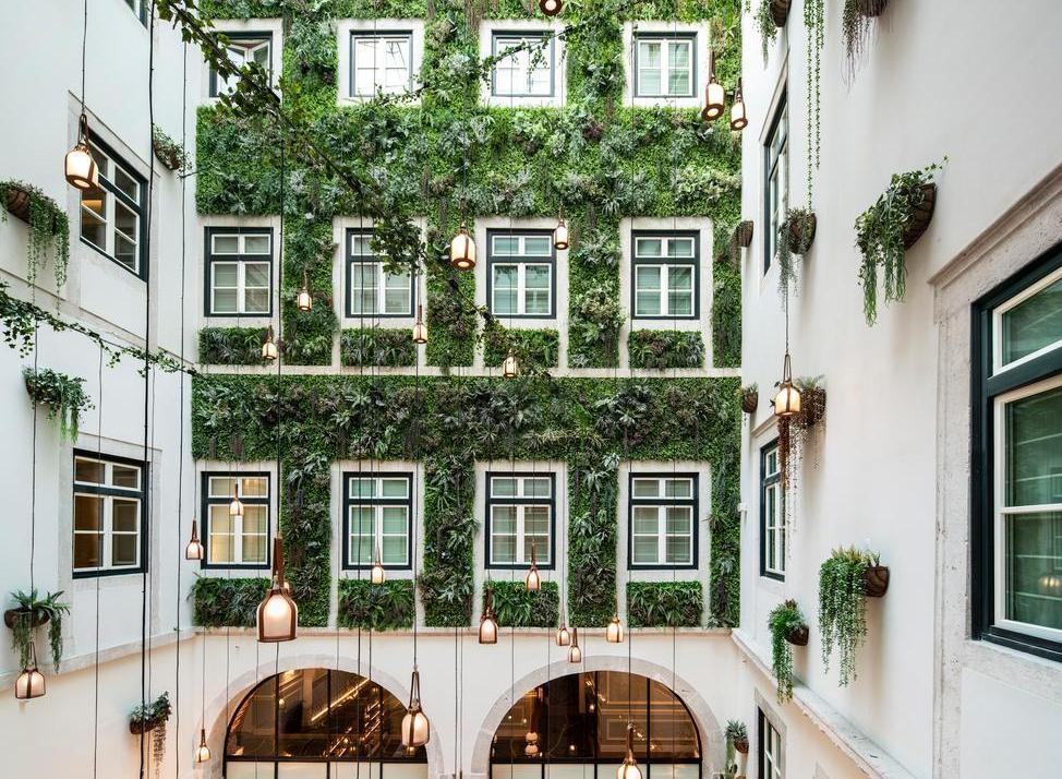 An interior courtyard with living wall covering the building at Palacio Ludovice in Lisbon