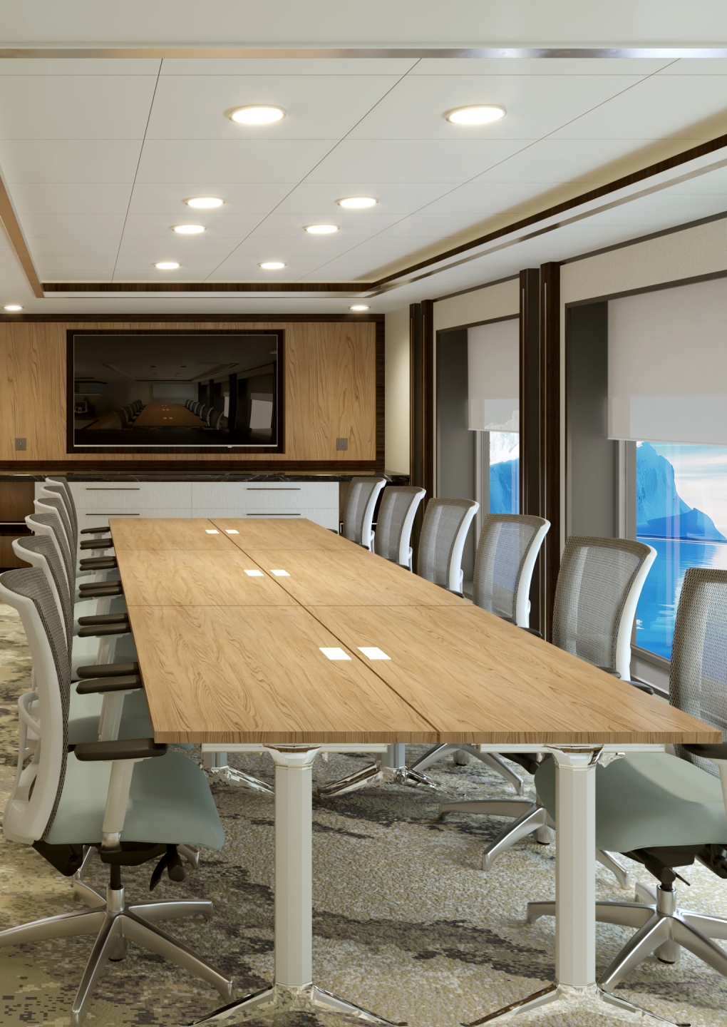 Long boardroom table with office chairs and neutral coloured carpet.