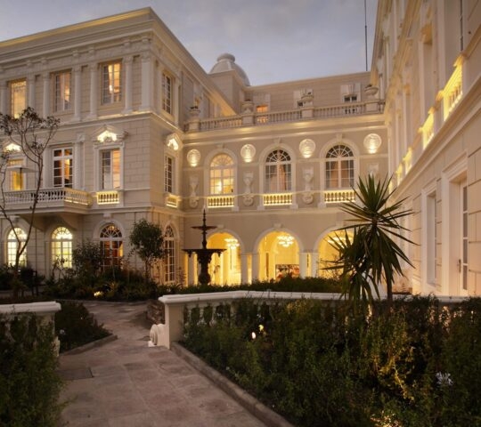 Exterior and patio area of Casa Gangotena illuminated at twilight, Quite, Ecuador