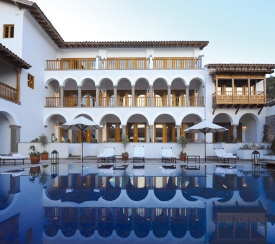 Exterior of Palacio Naxarenas reflected in the pool, Cusco, Peru