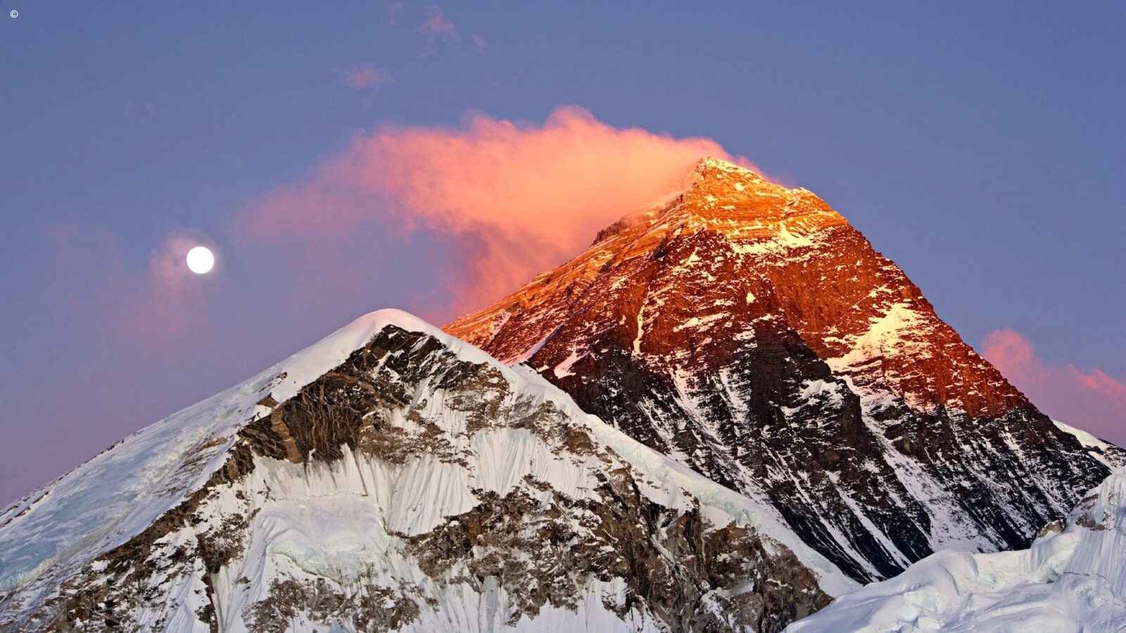 The summit of Mount Everest with clouds wisping across the top