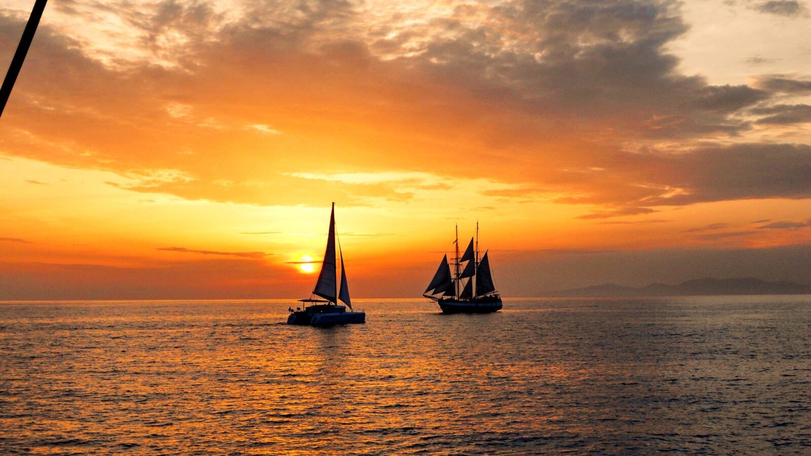Catamaran Santorini Greece Sailing around Santorini by catamaran is a great way to pass the time.