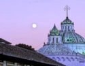 Full moon casting soft light on the Basilica del Voto Nacinoal in Quito, Ecuador at twilight