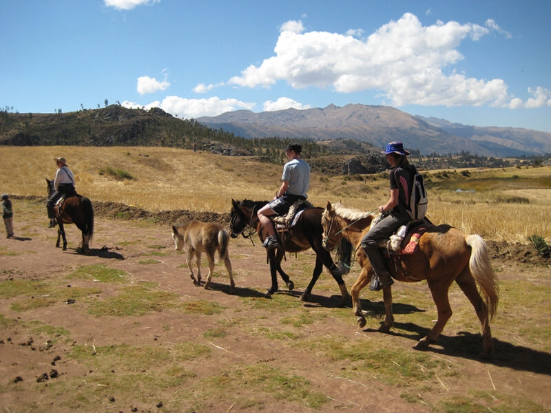 Luxury Peru Tours - People riding on horseback through the Sacred Valley in Peru