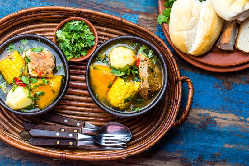 Two bowls of hearty vegetable and meat stew with bread, featured on luxury Chile tours.