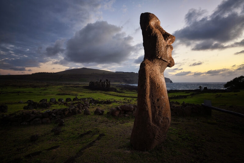 A side profile of a Moai stone statue at dusk, a staple of luxury Chile holidays.