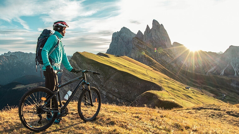 Luxury Italy Tours - mountain biker in front of mountains