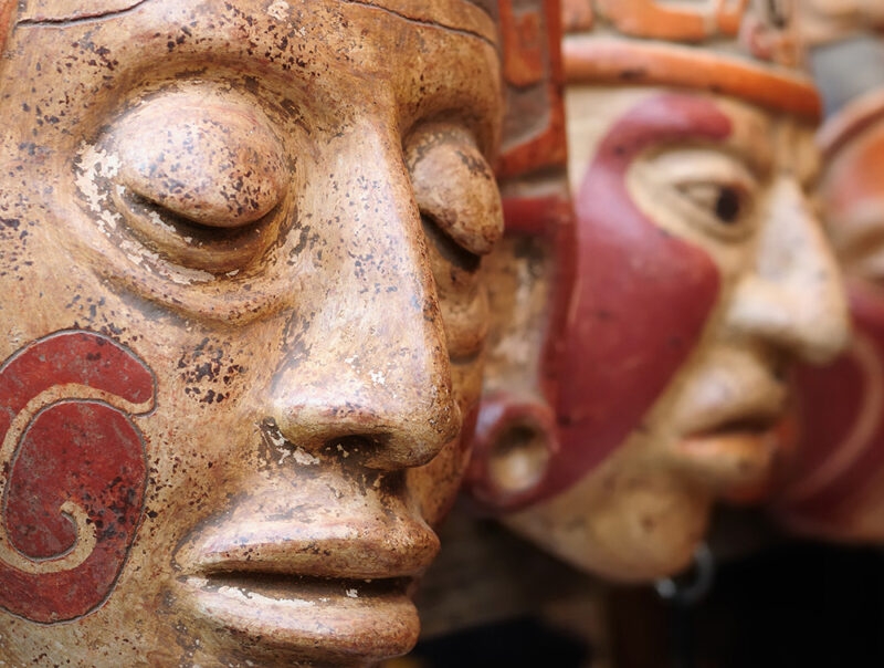 Close up of traditional Mayan clay masks at the Chichicastenango market in Guatemala