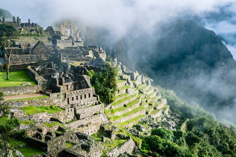 Ancient Inca village set in the mountains of Peru, surrounded by rolling clouds