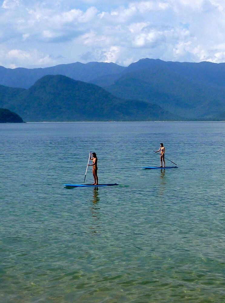Jacada Travel Brazil - Two people paddle boarding in calm water