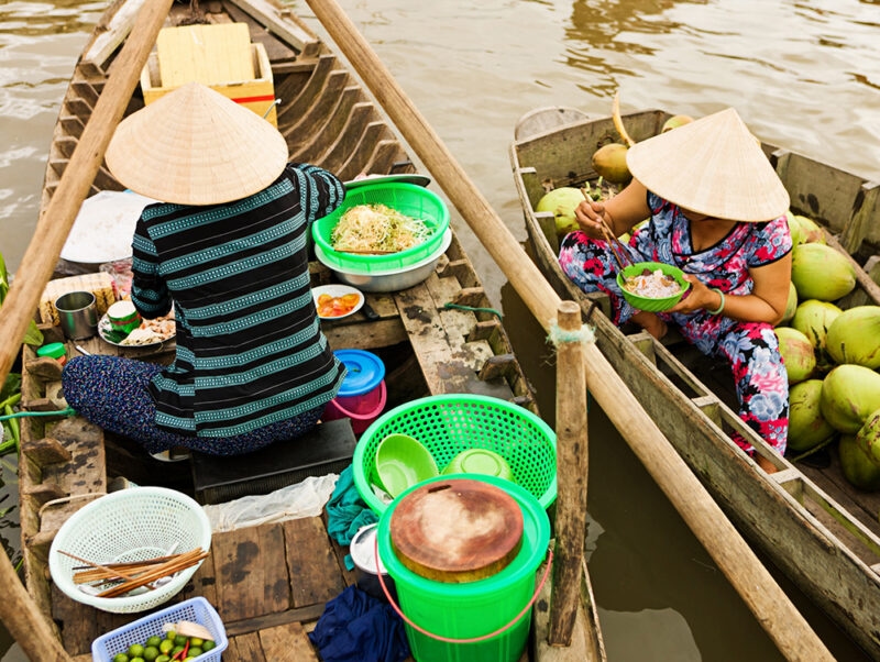 Luxury Vietnam Tours - Vietnamese woman selling Pho - noodle soup on floating market