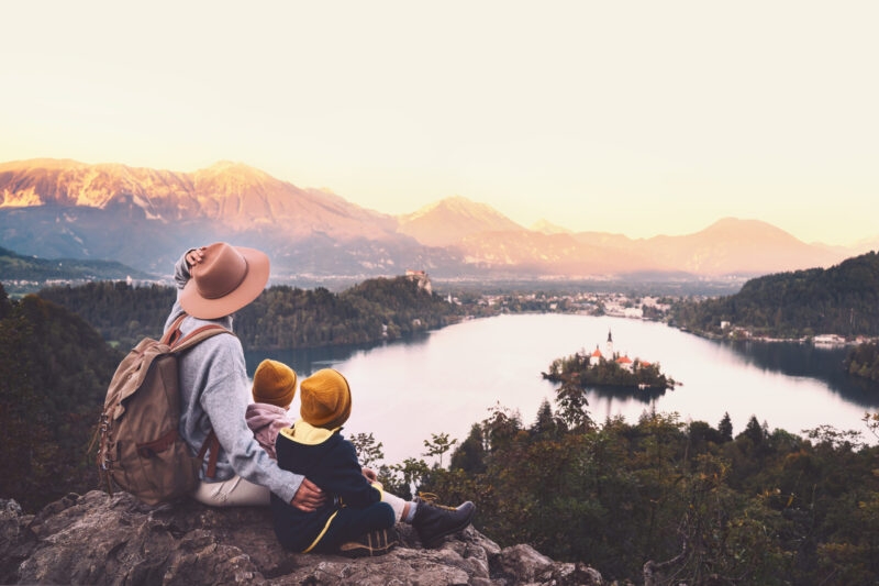 Luxury Grand Tours of Europe - family sitting on hill over lake bled at sunset