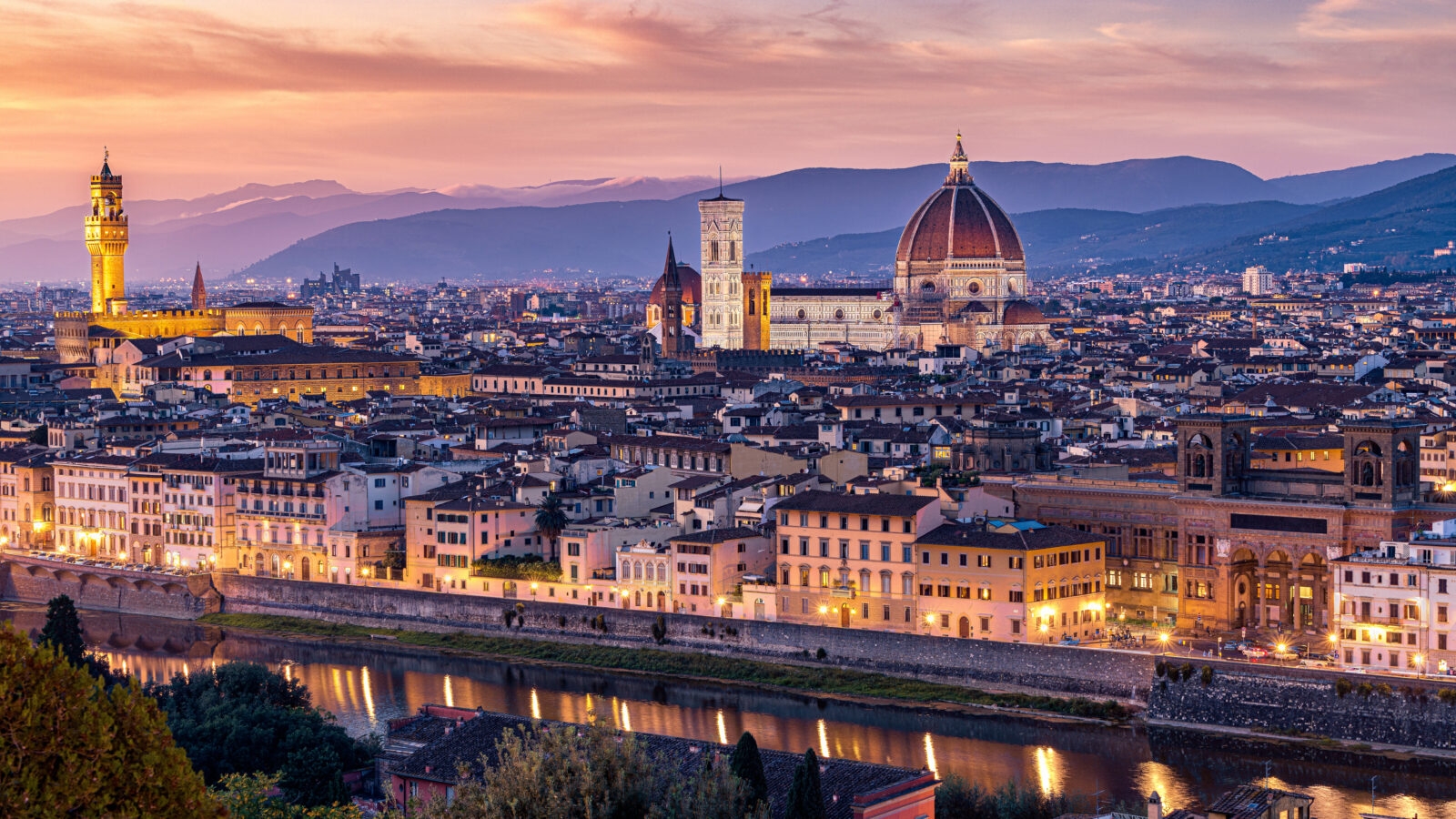 Luxury Grand Tours of Europe - Sunset over the city of Florence - view from hilltop a=outside the city showing the grand dome of the cathedral, city spires and rolling hills in the background