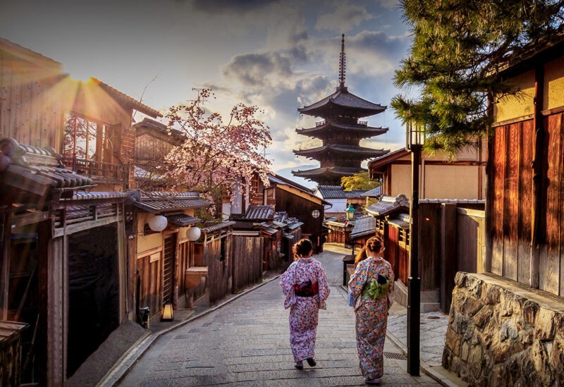 Arts, Culture & History trips - Gion is Kyoto's most famous geisha district. Pictured kere are two geisha's walking down a beautiful cobbled street during sunset.